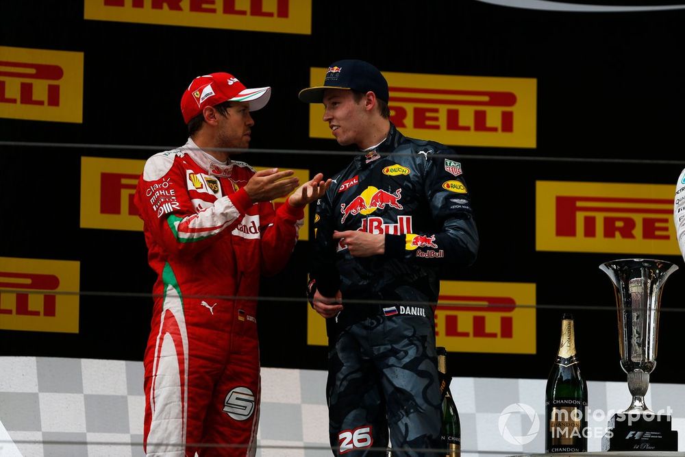 Sebastian Vettel, Ferrari, 2nd Position, has a word with Daniil Kvyat, Red Bull Racing, 3rd Position, about their start incident.