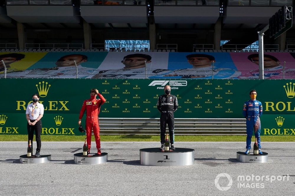 Charles Leclerc, Ferrari, Valtteri Bottas, Mercedes AMG F1, and Lando Norris, McLaren, celebrate on the podium after the race