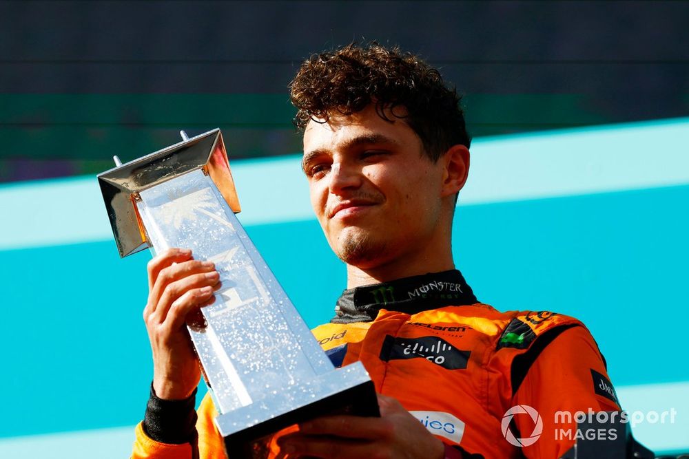 Lando Norris, McLaren F1 Team, 1st position, lifts the trophy in celebration on the podium 