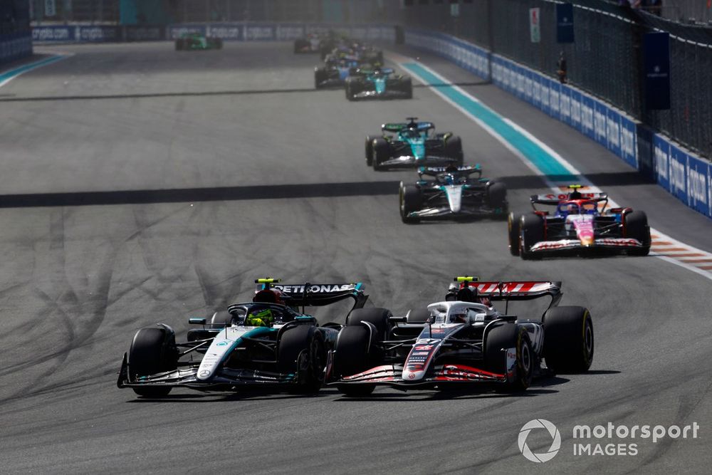 Lewis Hamilton, Mercedes F1 W15, battles with Nico Hulkenberg, Haas VF-24, ahead of Yuki Tsunoda, RB F1 Team VCARB 01