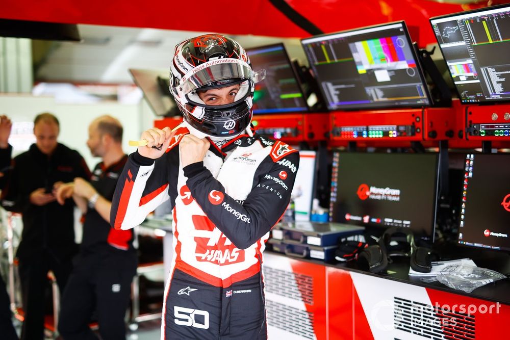 Oliver Bearman, Haas F1 Team, adjusts his helmet in the garage