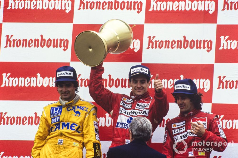 Nelson Piquet, 1st position, celebrates his first victory for McLaren on the podium. Alain Prost, 2nd position, and Nelson Piquet, 3rd position, are alongside.