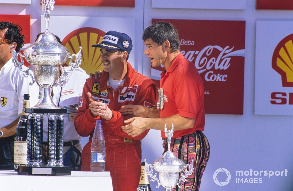 Nigel Mansell requiring attention having cut his hand on the winner's trophy.