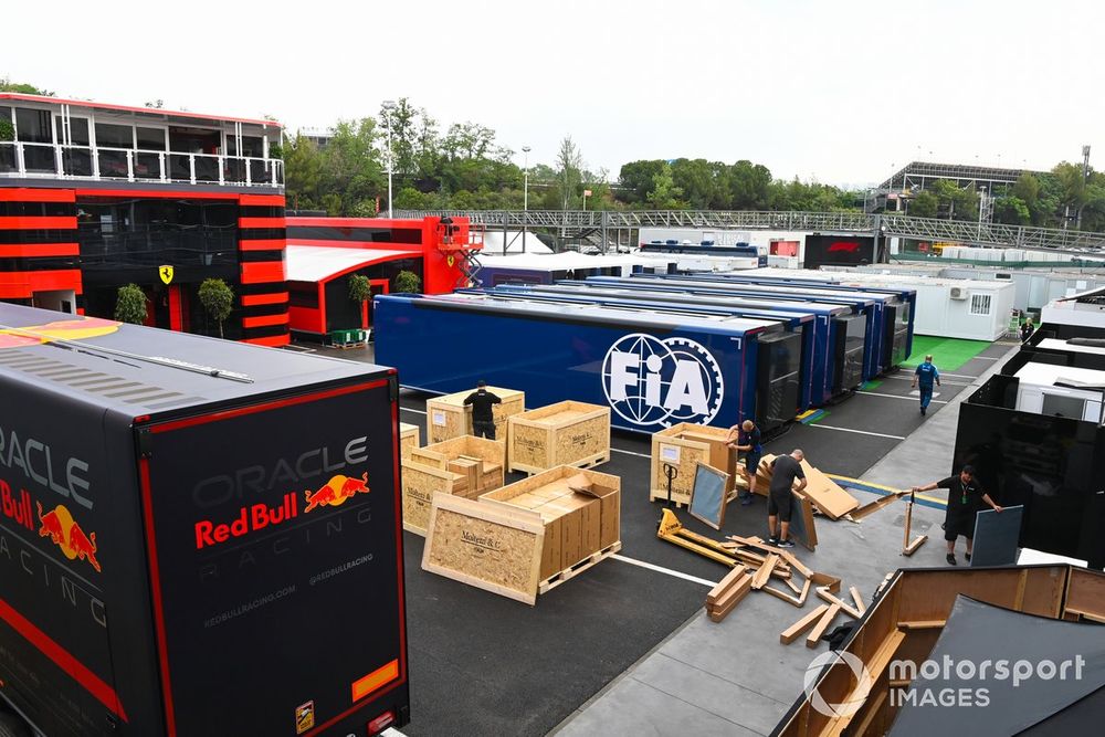 Crates are unpacked between Red Bull and FIA transporters