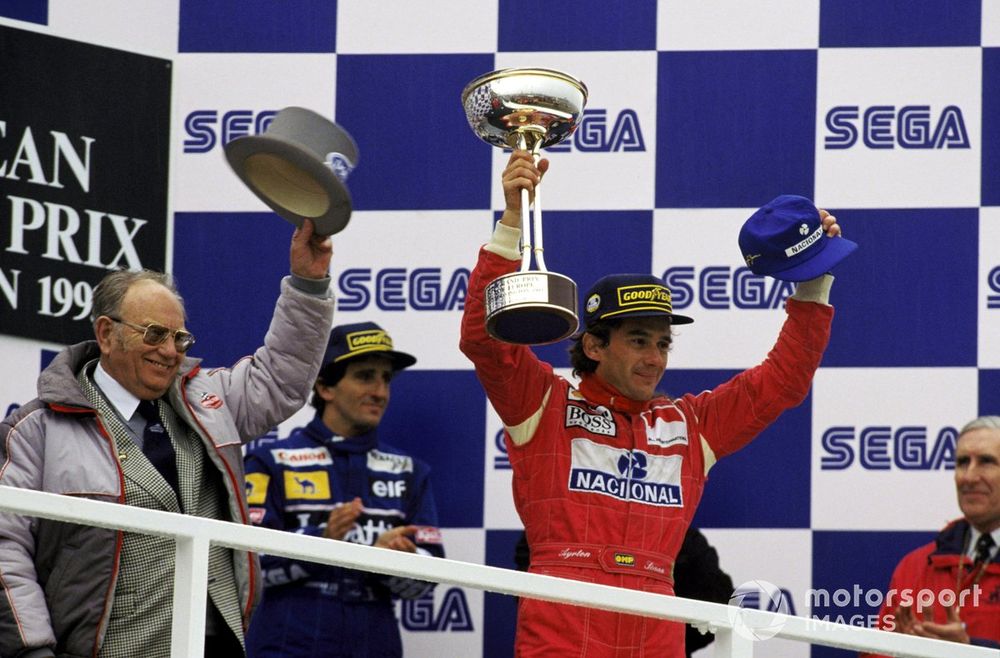 Ayrton Senna (BRA) McLaren (Right) celebrates, on the podium, arguably his greatest ever victory with Tom Wheatcroft (GBR) (Left), celebrating the realisation of his dream of having Donington host a Grand Prix, and Alain Prost (FRA) Williams (Centre), who finished third.